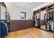 Organized walk-in closet with custom built-in storage and hardwood flooring at 200 Magnolia St, Denver, CO 80220
