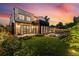 Outdoor space with lush green grass, cozy seating, and a modern home exterior at dusk at 200 Magnolia St, Denver, CO 80220