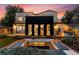 Well-lit backyard with a modern fire pit, outdoor seating, and a home with sleek black accents at 200 Magnolia St, Denver, CO 80220