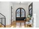 Inviting foyer with herringbone wood floors, arched double doors, and a console table with decorative mirror at 200 Magnolia St, Denver, CO 80220