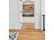 Hallway with hardwood flooring, a built in bookshelf, and white trim at 200 Magnolia St, Denver, CO 80220