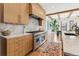 Gourmet kitchen with stainless steel range, wood cabinets, marble backsplash, and a view of the dining area at 200 Magnolia St, Denver, CO 80220