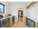 Well-equipped laundry room with modern appliances and custom cabinetry at 200 Magnolia St, Denver, CO 80220