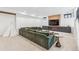 Basement living area features a sectional sofa, accent lighting, and neutral colors at 200 Magnolia St, Denver, CO 80220