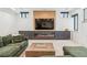 Basement living room with a modern entertainment unit, fireplace, and comfortable seating at 200 Magnolia St, Denver, CO 80220