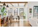 Open concept living area with a dining table and breakfast bar that joins to a comfortable seating area at 200 Magnolia St, Denver, CO 80220
