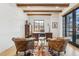 Home office featuring wood beams, two leather chairs, a cowhide rug, and a large desk with office chair at 200 Magnolia St, Denver, CO 80220
