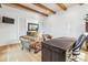 Office space features wood beams, leather chairs, a large desk, white board, and a view of the entry at 200 Magnolia St, Denver, CO 80220