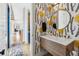 Stylish powder room features unique wallpaper, a floating wood vanity, and a round mirror at 200 Magnolia St, Denver, CO 80220