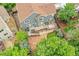 Aerial view of the home's backyard with a deck, patio, lush landscaping, providing a private oasis at 8838 S Dudley St, Littleton, CO 80128