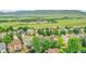 Scenic aerial view of a suburban neighborhood, showcasing lush greenery and mountain views at 8838 S Dudley St, Littleton, CO 80128