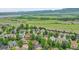 Picturesque aerial view of a residential neighborhood with lush greenery, and stunning mountain views at 8838 S Dudley St, Littleton, CO 80128