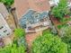 Aerial view of the home showcasing the deck, stone patio, and mature landscaping at 8838 S Dudley St, Littleton, CO 80128