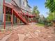 Backyard patio featuring decorative rock and a stone paver patio with artificial turf at 8838 S Dudley St, Littleton, CO 80128