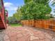 Landscaped backyard featuring a stone patio and a cozy fire pit, ideal for outdoor gatherings at 8838 S Dudley St, Littleton, CO 80128