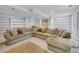 Spacious finished basement featuring a large sectional sofa and built-in shelving units at 8838 S Dudley St, Littleton, CO 80128