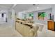 Finished basement featuring a large sectional couch and direct access to the backyard at 8838 S Dudley St, Littleton, CO 80128