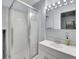 Bathroom featuring a glass shower and a white vanity with a mirror and vanity lights at 8838 S Dudley St, Littleton, CO 80128