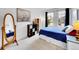 Bright bedroom featuring two windows, light-colored carpet, and modern decor at 8838 S Dudley St, Littleton, CO 80128