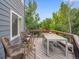 Large back deck with outdoor seating area and wood railing at 8838 S Dudley St, Littleton, CO 80128