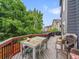 Large back deck with outdoor seating area, mature trees, and neighborhood views at 8838 S Dudley St, Littleton, CO 80128
