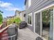 Spacious deck featuring grey siding, red railing, and an outdoor grill with cover at 8838 S Dudley St, Littleton, CO 80128