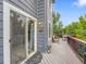 Outdoor deck area featuring grey siding, an outdoor light fixture, and outdoor furniture at 8838 S Dudley St, Littleton, CO 80128