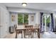 Cozy dining area with natural light, wooden table and access to the outdoor deck at 8838 S Dudley St, Littleton, CO 80128