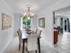Elegant dining room with chandelier, neutral colors, and ample natural light at 8838 S Dudley St, Littleton, CO 80128