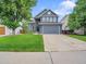 Charming two-story home with a well-manicured lawn and attached two-car garage at 8838 S Dudley St, Littleton, CO 80128