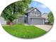 Charming two-story home with a well-manicured lawn and attached two-car garage at 8838 S Dudley St, Littleton, CO 80128