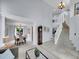 Spacious foyer with staircase and views of the dining room and living areas at 8838 S Dudley St, Littleton, CO 80128