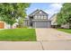 Charming two-story home with a well-maintained lawn, mature tree and a two car garage at 8838 S Dudley St, Littleton, CO 80128