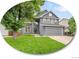 Charming two-story home with a well-maintained lawn, mature tree and a two car garage at 8838 S Dudley St, Littleton, CO 80128