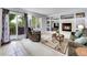 Cozy living room featuring a fireplace, built-in shelving, and access to the deck at 8838 S Dudley St, Littleton, CO 80128
