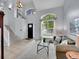 Bright living room with high ceilings, large windows, and neutral decor at 8838 S Dudley St, Littleton, CO 80128