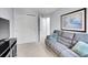 Comfortable living room with a grey sofa, large closet, and neutral walls at 8838 S Dudley St, Littleton, CO 80128