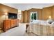 Spacious main bedroom with a large dresser, trunk, and an ensuite bathroom at 8838 S Dudley St, Littleton, CO 80128