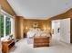 A well-lit main bedroom featuring carpet floors, wooden furniture and a large window at 8838 S Dudley St, Littleton, CO 80128