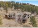 Aerial view showcasing the house nestled among trees and scenic landscape at 12653 Rancho Ct, Conifer, CO 80433