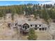 Aerial view showcasing the house nestled among trees and scenic landscape at 12653 Rancho Ct, Conifer, CO 80433
