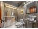 Unique bathroom with stainless steel shower, toilet, pedestal sink, and industrial-style decor at 12653 Rancho Ct, Conifer, CO 80433