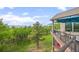 Multi-level deck featuring comfortable seating, umbrellas, and stunning views of the lush greenery and mountains beyond at 12653 Rancho Ct, Conifer, CO 80433