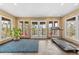 Bright exercise room with large windows and a walk-out, complete with a treadmill and natural light at 12653 Rancho Ct, Conifer, CO 80433