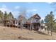 Beautiful exterior view of a multi-story home with multiple decks and large windows at 12653 Rancho Ct, Conifer, CO 80433