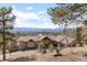 Expansive ranch style home with mountain views and a spacious front yard and driveway at 12653 Rancho Ct, Conifer, CO 80433
