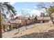 Long driveway to a beautiful ranch-style home with garage and side entrance, surrounded by trees at 12653 Rancho Ct, Conifer, CO 80433