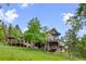 Rear exterior view showcasing multiple decks perfect for enjoying the natural surroundings at 12653 Rancho Ct, Conifer, CO 80433