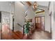 Grand entrance foyer with high ceilings, chandelier, tile flooring and wood accents throughout at 12653 Rancho Ct, Conifer, CO 80433