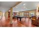 Spacious game room with pool table, bar area, and hardwood floors perfect for entertaining at 12653 Rancho Ct, Conifer, CO 80433